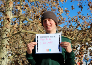 SOS Outreach participant holding a sign saying what he learned