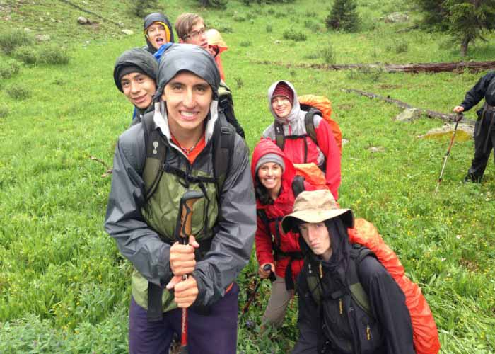 SOS Outreach on a hike through a rainy forest