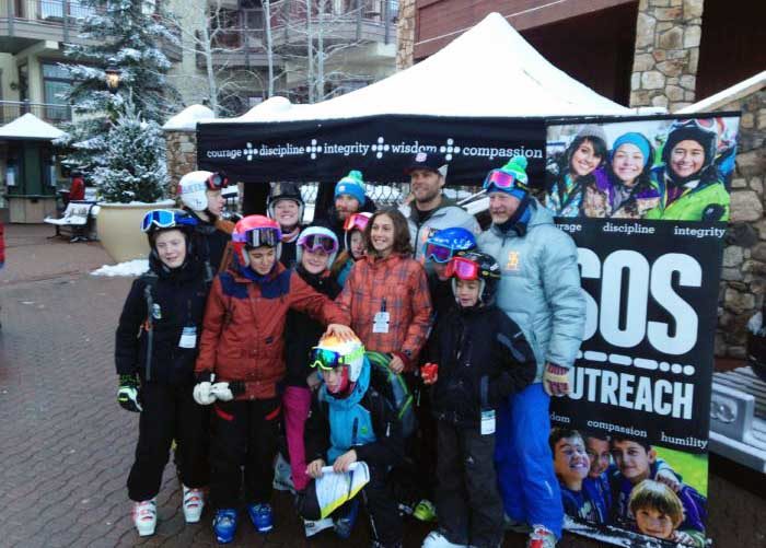 SOS Outreach youth dressed in snow gear at an event