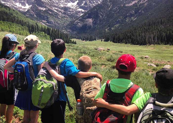 SOS Outreach youth on a hike through beautiful mountains