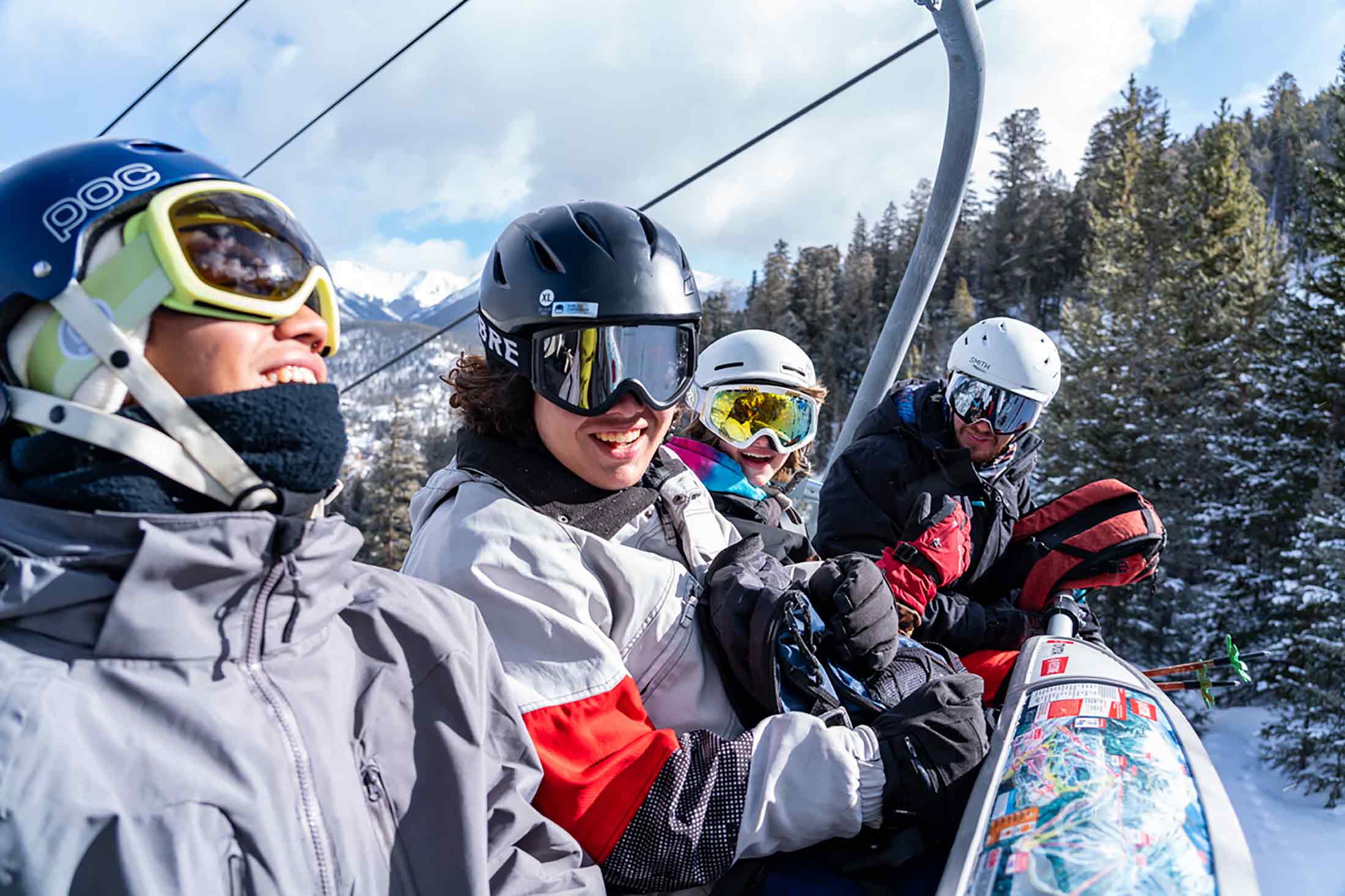 Skiers on a chair lift in Summit County